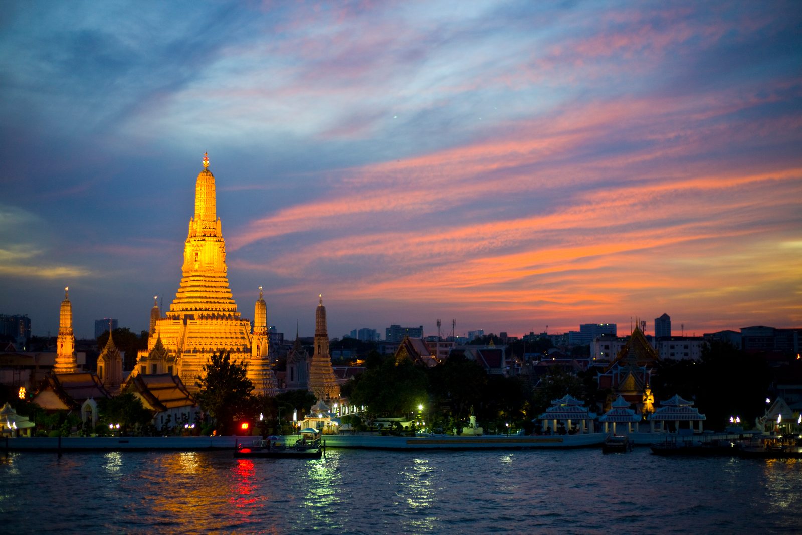 Wat Arun temple at sunset on the Chao Phraya river, Bangkok