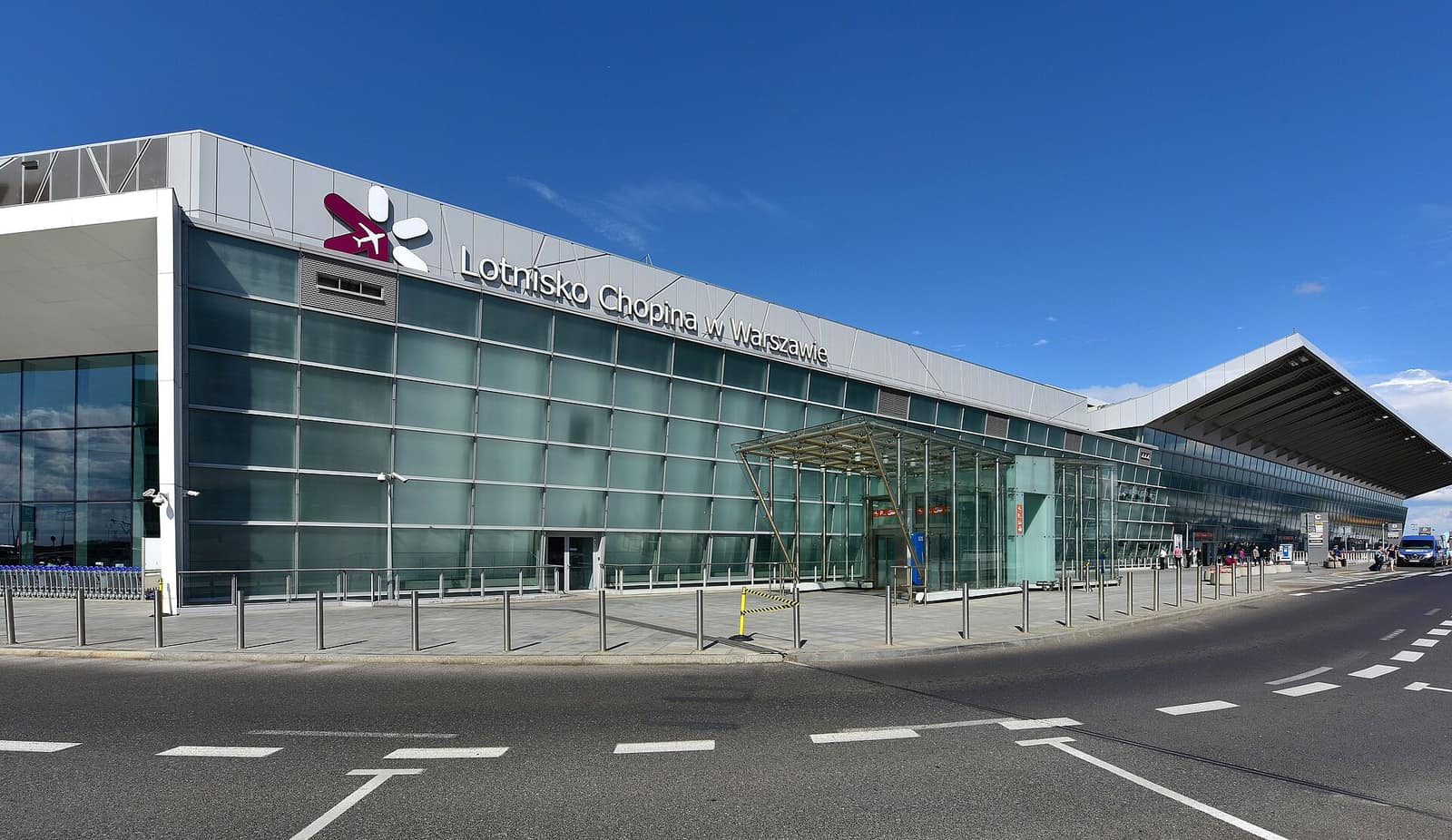 Glass facade of the terminal at Warsaw Chopin Airport with the Lotnisko Chopina w Warszawie sign